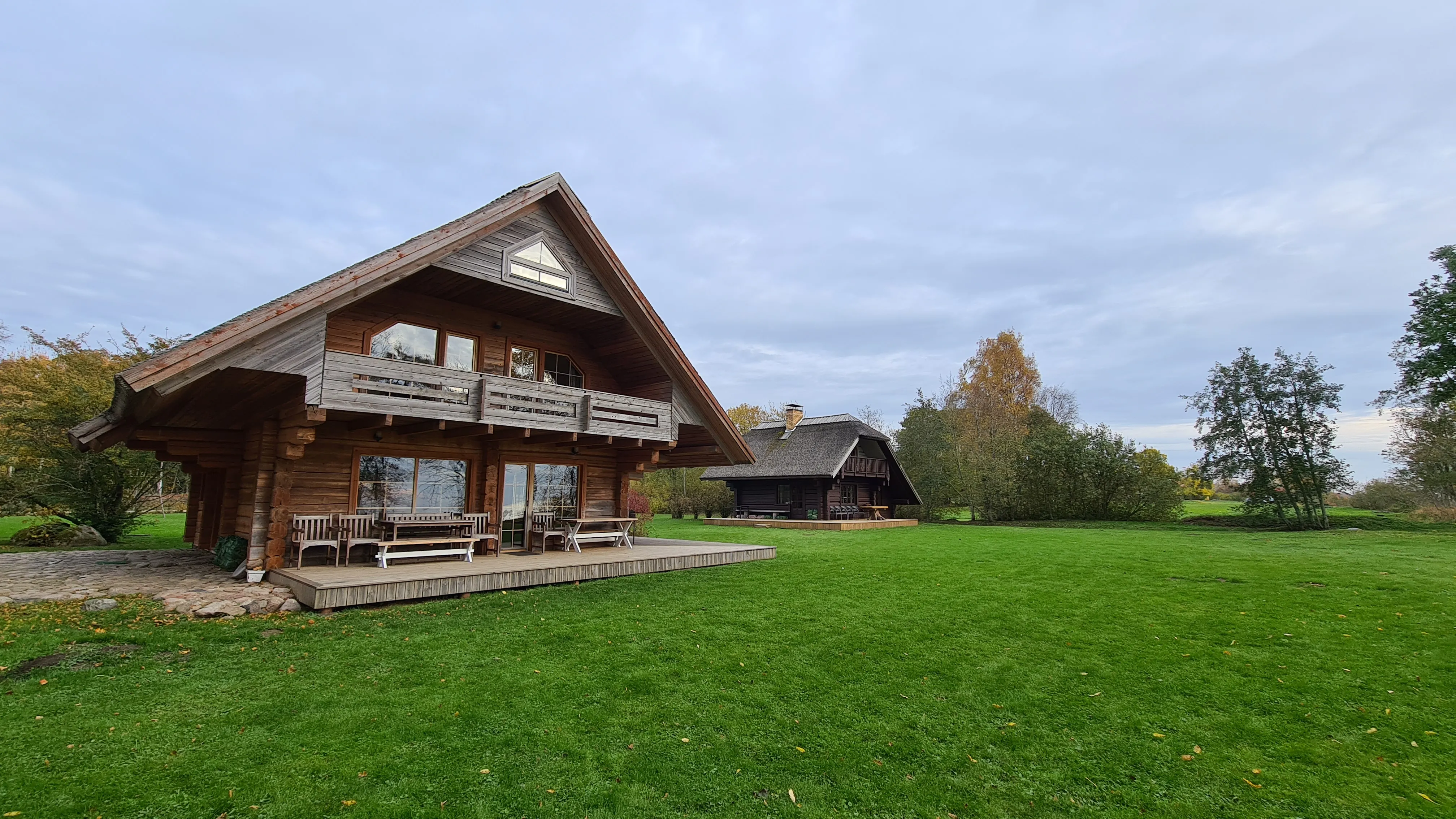 The Klintskalni 1 property with the log house and the cottage behind, seen from the garden